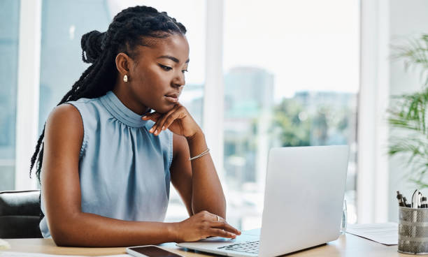 istock Serious young black businesswoman thinking while working on a laptop in an office alone 1394347395