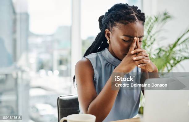 Stressed Black Businesswoman Working On A Laptop In An Office Alone Stock Photo - Download Image Now