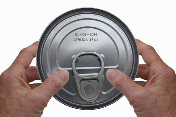 istock Hands holding a tin can with an expiration date marked on it 1394347806