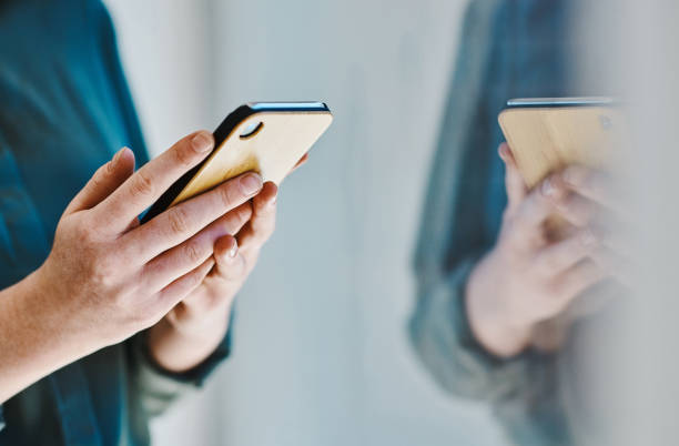istock Hands of a caucasian woman browsing on a cellphone while working in an office alone 1394348871