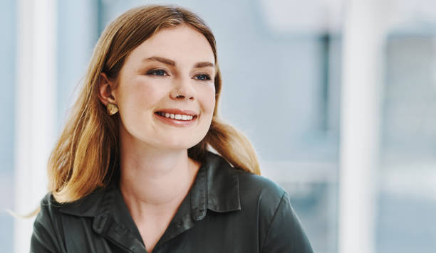istock Confident caucasian businesswoman smiling while thinking in an office alone 1394349519