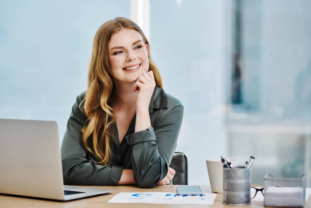 istock Young businesswoman thinking while working on a laptop in an office alone 1394349667