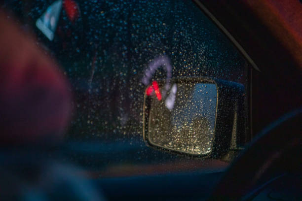 istock night car driving rain drops on window 1394350978