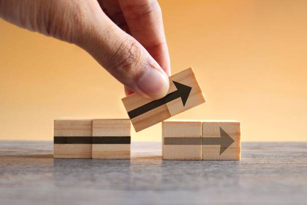 New strategy, changes, alternative path, and improvement Hand holding wooden cubes with arrow icon. New strategy, changes, alternative path, and improvement adaptation concept stock pictures, royalty-free photos & images