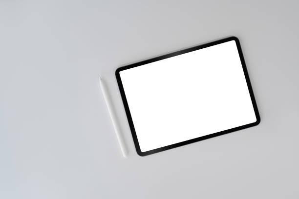 istock Digital tablet with blank screen and stylus pen on white background. Top view, flat lay, copy space. 1394354497