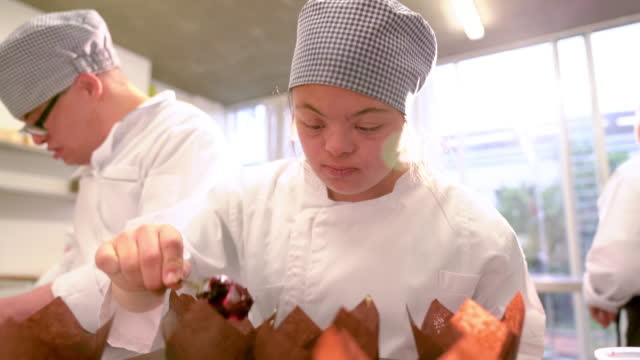 Young woman with Down Syndrome baking in class