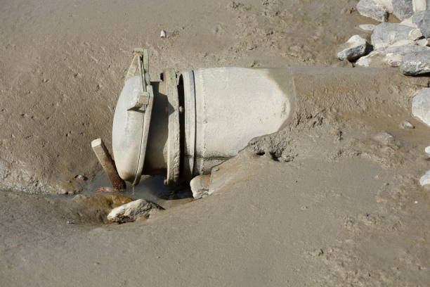 Silt in the mudflats at low tide, Germany Pipe and silt in the mudflats at low tide, Germany abwasser stock pictures, royalty-free photos & images