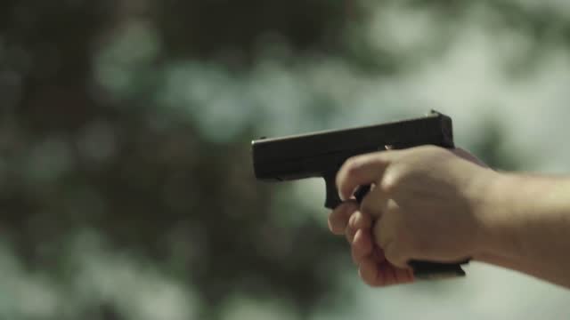 The process of shooting a pistol at the shooting range, close-up