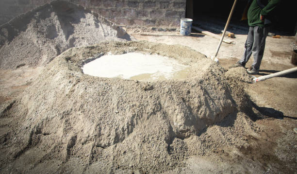 istock Worker prepare concrete with shovel at construction site. 1394359565
