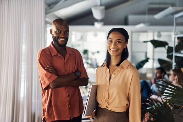 istock Two businesspeople standing together in an office at work 1394360122
