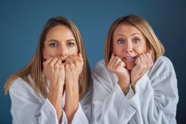 istock Two girls wearing bathrobe in spa or hotel having fun 1394363140