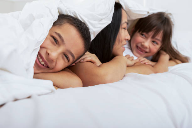 istock Bonding with mommy in bed 1394364184