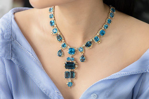 Necklace made of silver and aquamarine and gold. Elegant design for the beauty of jewelry.