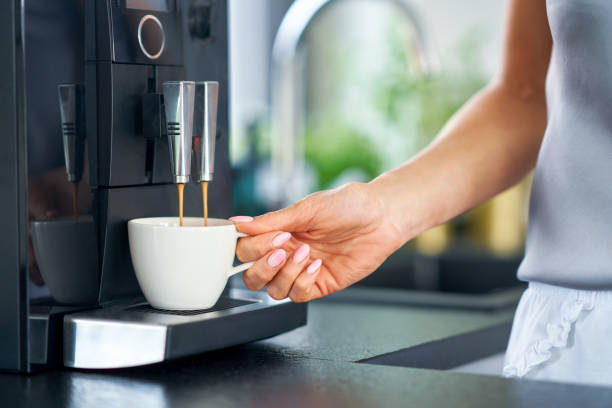 istock Nice woman making coffee in the kitchen 1394367009