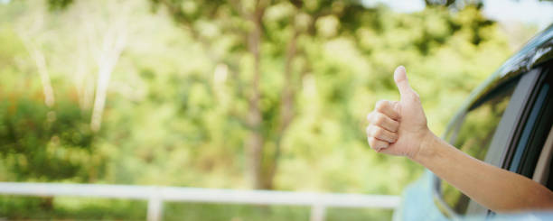 istock Driver showing a thumb up outside the window. 1394371385
