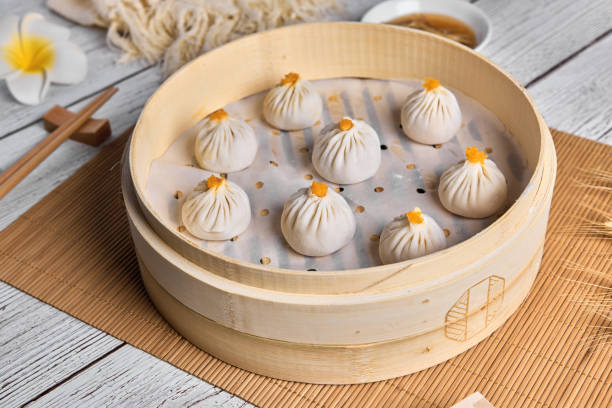 istock Asian Buns or Xiaolongbao in bamboo basket. Ready for steam. 1394372121