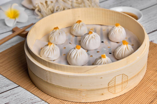 istock Asian Buns or Xiaolongbao in bamboo basket. Ready for steam. 1394372132