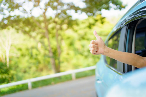 istock Driver showing a thumb up outside the window. 1394372219
