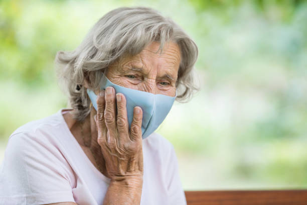 istock Elderly woman wearing a protective face mask against viruses 1394372304