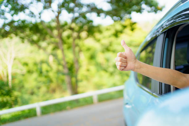 istock Driver showing a thumb up outside the window. 1394372367