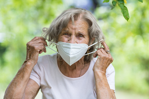 Elderly woman wearing a protective face mask against corona virus
