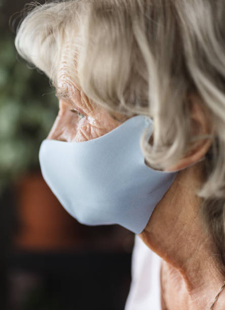 istock Elderly woman with a face mask 1394373260