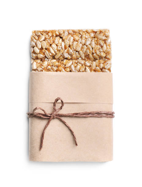 istock Wrapped delicious kozinaki bar isolated on white, top view 1394374536