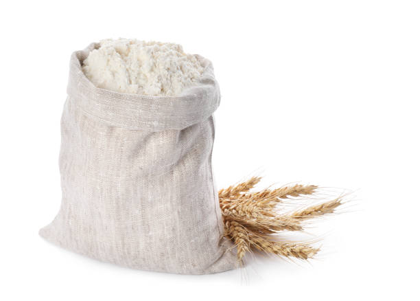 istock Sack with flour and wheat spikes on white background 1394374711