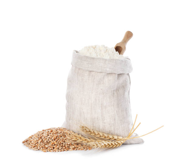 istock Sack with flour, wheat grains and spikes on white background 1394375314