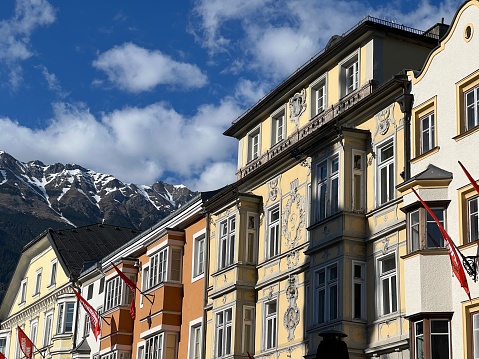 colorful buildings in innsbruck austria with clear blue sky and mountains