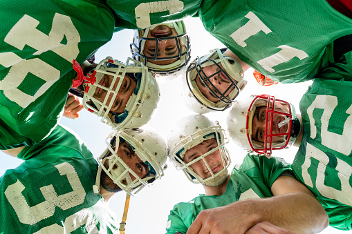 American Football Players Huddling During Time Out