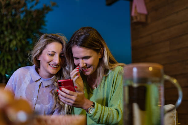 istock Happy friends using a phone on a terrace 1394380307