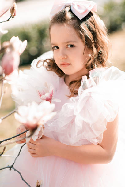 istock Cute baby with blooming flower tree 1394381558
