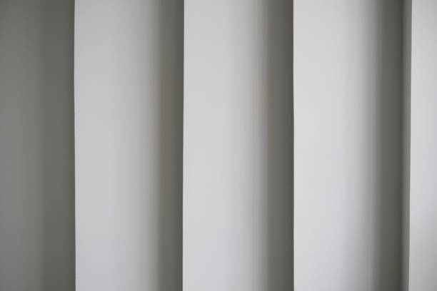 istock modern architecture detail. Abstract angular building wall, futuristic gray abstract background with shadows. fragment of contemporary office interior. Curvilinear column. futuristic gray abstract background. 1394382565