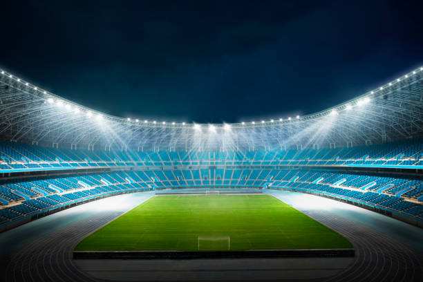 View of empty sports stadium at night with spotlights illuminating field View of empty sports stadium at night with spotlights illuminating field, digitally generated image scoreboard stadium sport seat stock pictures, royalty-free photos & images