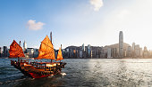istock Hong Kong's Victoria Harbor with traditional red sail junk boat 1394385528