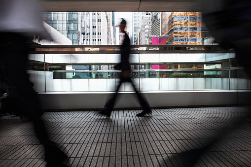 Businessman walking alone in corridor in the Central District of Hong Kong