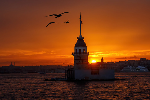 Sunset over Bosphorus with famous Maiden's Tower - Kiz Kulesi - Leander's Tower, symbol of Istanbul, Turkey.