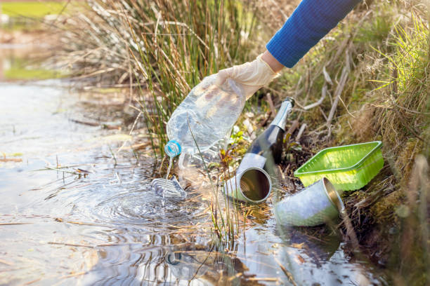 istock Environmental conservation collecting garbage and trash from water 1394387098