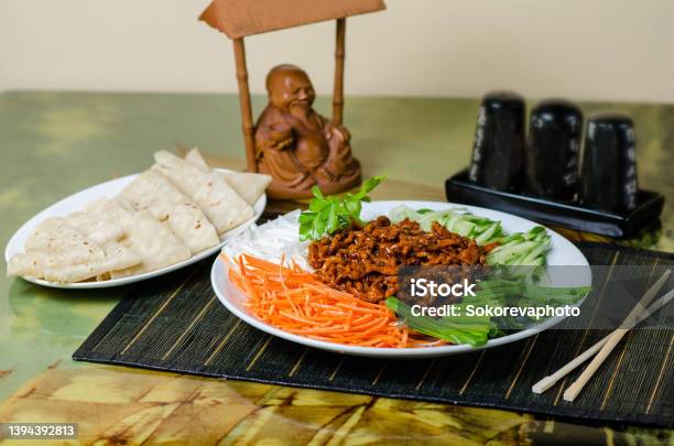 Peking Pork Pork Is Served With Carrots Cucumbers Green Onions Dish In A Chinese Restaurant Stock Photo - Download Image Now