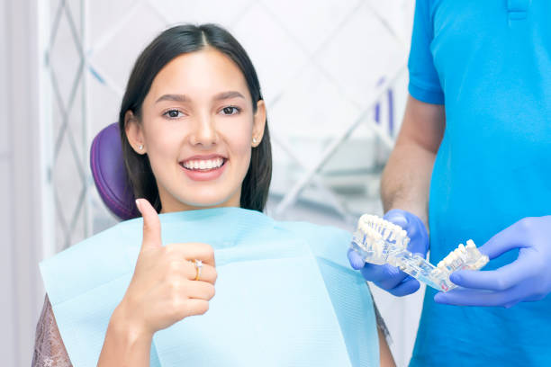 istock dentist examines the patients teeth at the dentist. shows like 1394395680