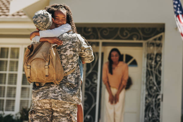 istock Army soldier embracing his daughter after returning home 1394396838