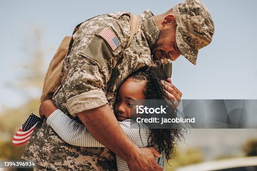 istock Emotional soldier saying farewell to his daughter 1394396934