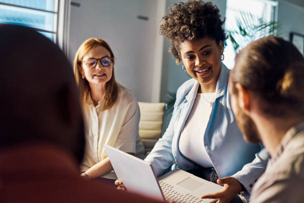 istock Young hispanic businesswoman using a laptop while talking in a meeting at work 1394400285