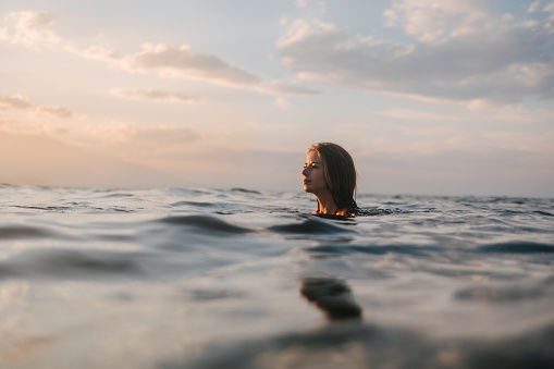 Swimming in the sea at sunset