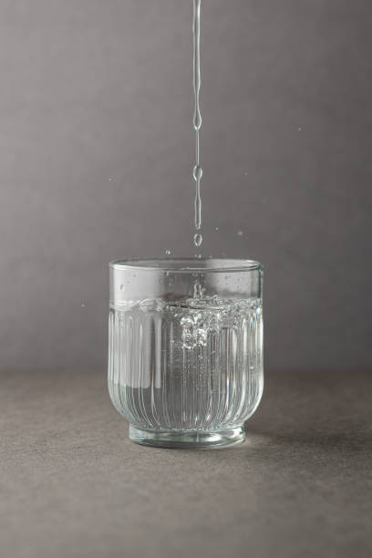 istock Glass with spring water against a grey background 1394400915