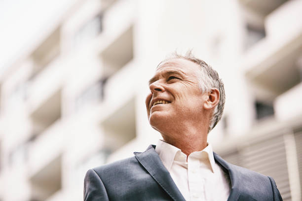 Middle age man in front of office A middle-aged white man wearing a jacket with a business office behind old rich white guy stock pictures, royalty-free photos & images