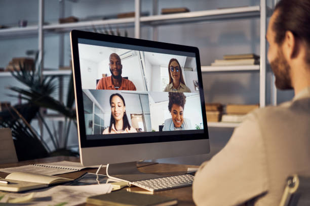 Group of five businesspeople in a virtual meeting using a computer at work stock photo