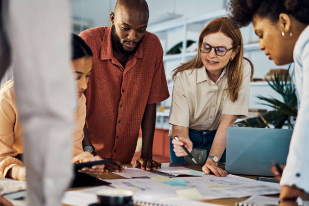 istock Five businesspeople having a meeting around a table at work 1394402069