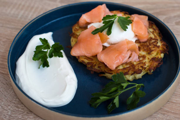 istock Fried draniki with red salted fish and poached egg. A dish decorated with herbs and sour cream 1394402072